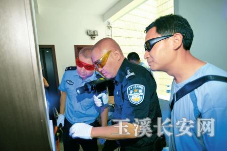 杨松(中)在案件现场寻找指纹(市公安局提供)